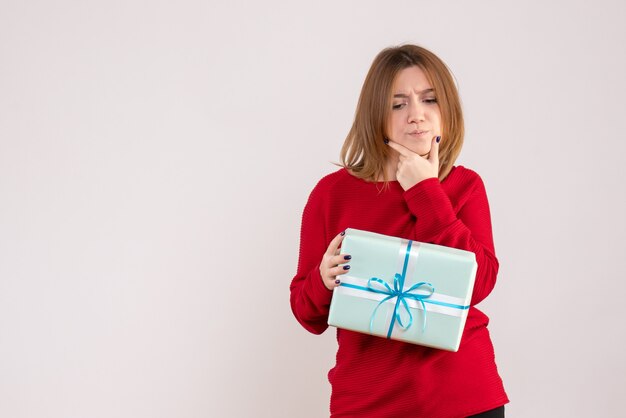 Front view young female standing with xmas present