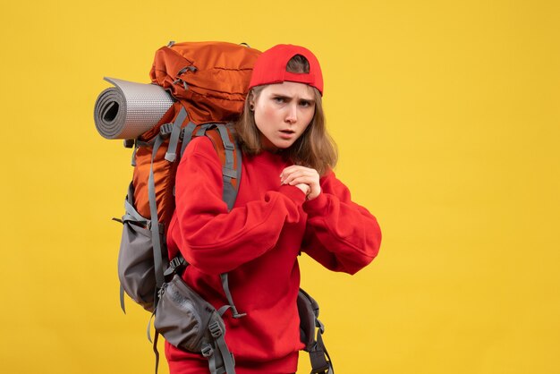 Front view young female traveler with backpack ready to fight