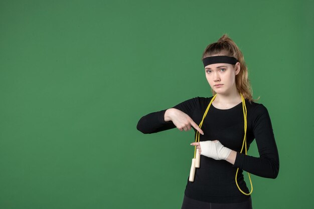 Front view young female with bandage around her hurt arm on green background athlete workout flex health woman injury sport body hospital