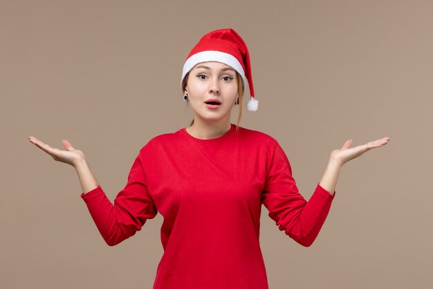 Front view of young female with christmas cape on brown