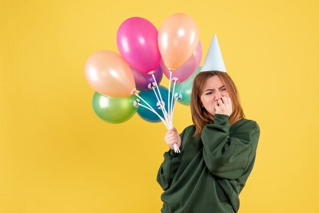 Front view young female with colorful balloons stressed