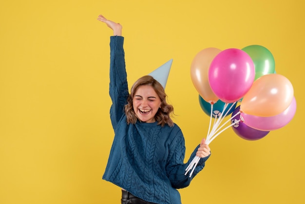 Free photo front view young female with colorful balloons