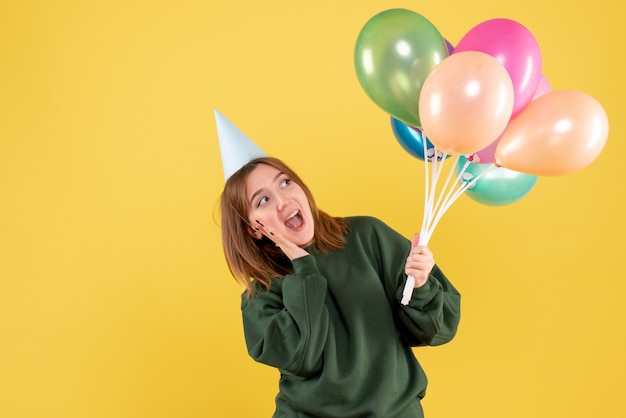 Front view young female with colorful balloons