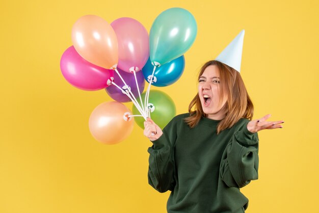 Front view young female with colorful balloons