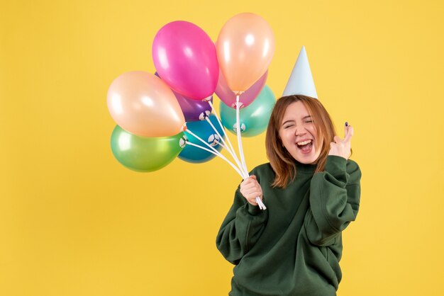 Front view young female with colorful balloons