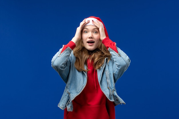 Free photo front view young female with excited expression on blue background christmas emotion color