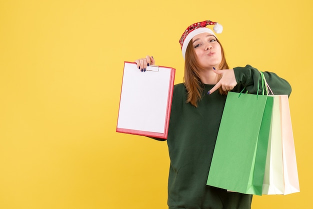 Free photo front view young female with file note and shopping packages