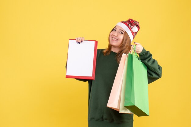 Free photo front view young female with file note and shopping packages