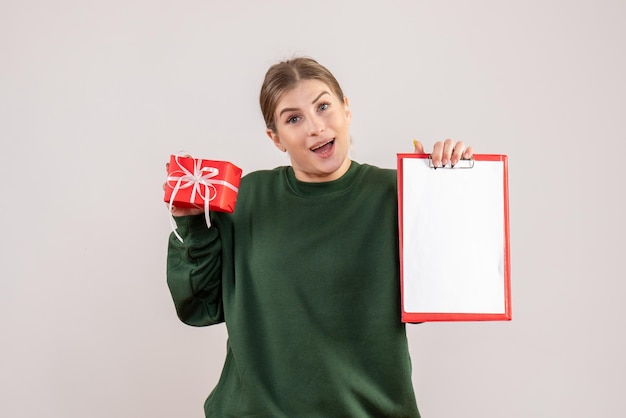 Free photo front view young female with little xmas present and note