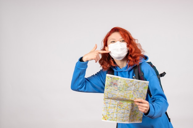 Free Photo front view of young female with map in mask on white wall