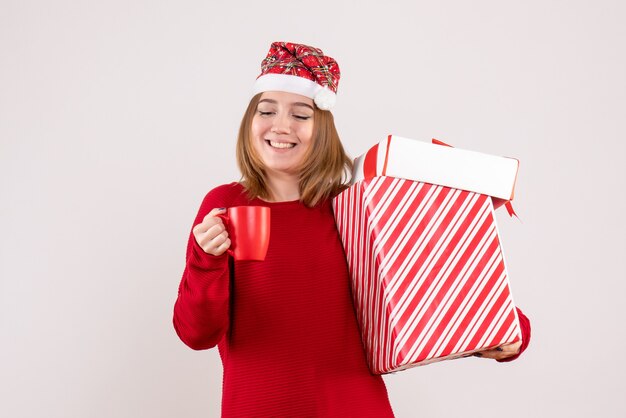 Front view young female with present and cup of tea