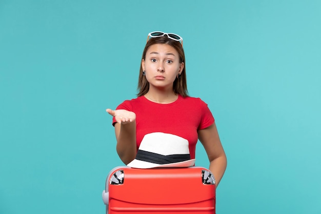 Front view young female with red bag and hat on it on the blue space