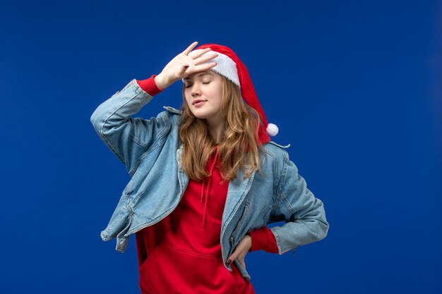 Front view young female with red christmas cap on blue background christmas emotions color