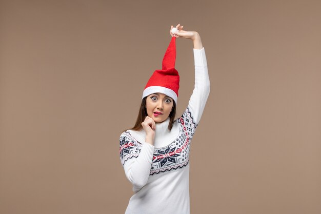 Front view young female with red christmas cap on brown desk christmas holiday emotions