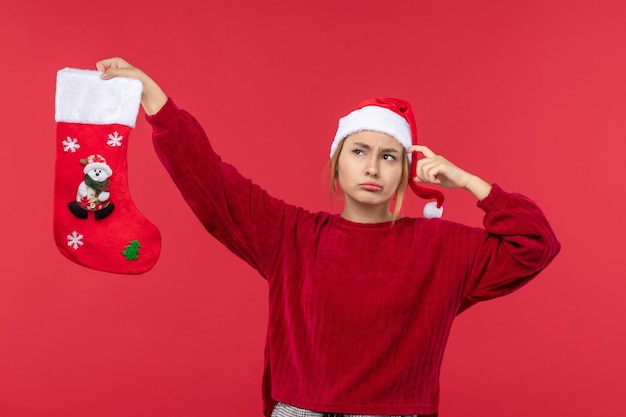 Free Photo front view young female with red christmas sock, christmas red holiday