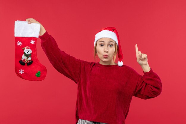 Front view young female with red christmas sock on red desk christmas red holiday