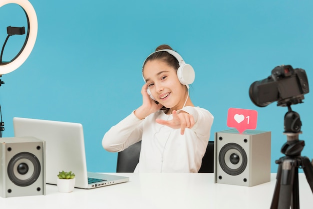 Front view young girl recording for personal blog