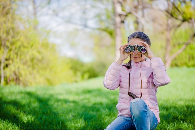 Free Photo front view of young girl with binoculars