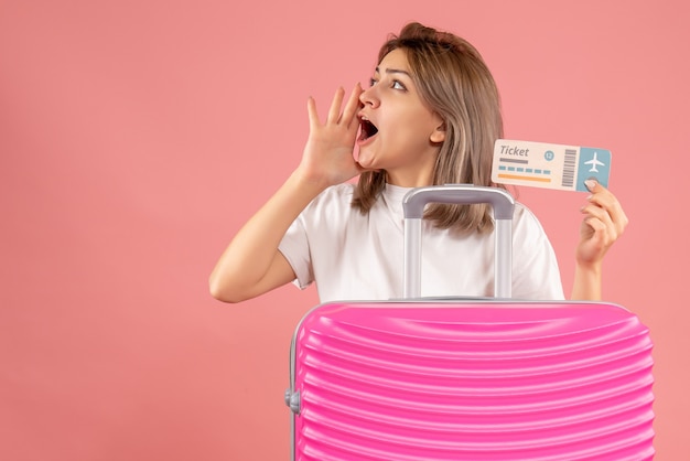 Free Photo front view young girl with pink suitcase holding ticket calling someone