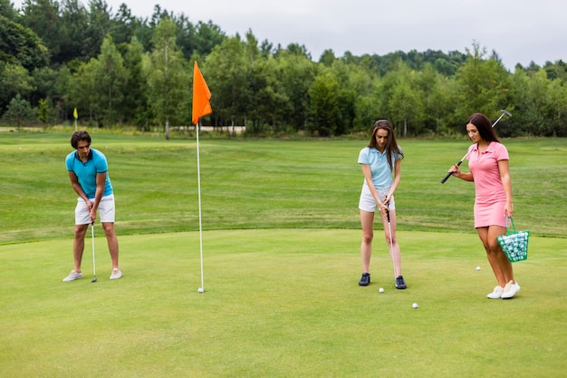 Free photo front view of young golfers playing