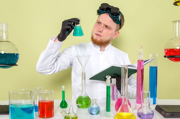 Front view young guy staring at light blue chemical