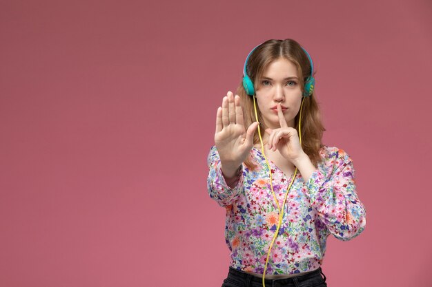 Front view young lady shows stop and silence gestures