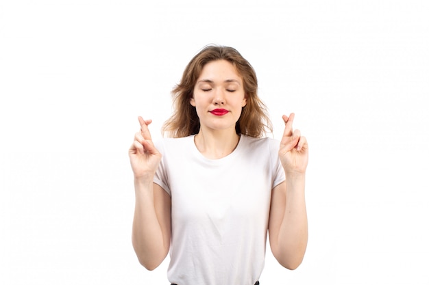 Free Photo a front view young lady in white shirt and black modern jeans wishing on the white