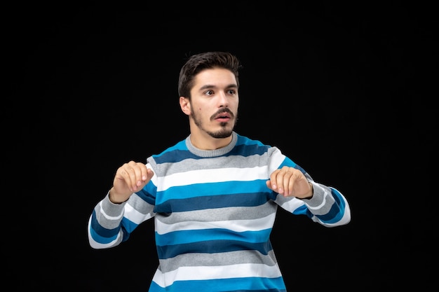 Free Photo front view young male in blue striped jersey on black wall