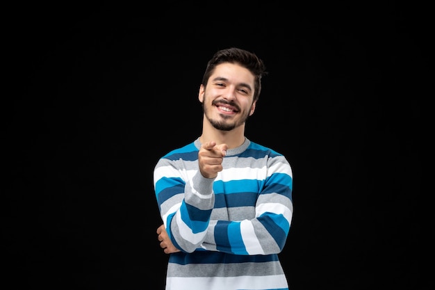 Free Photo front view young male in blue striped jersey on the black wall