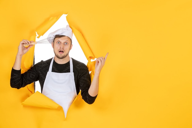 Free Photo front view young male cook in white cape holding whisk on yellow background photo food cuisine kitchen white color man