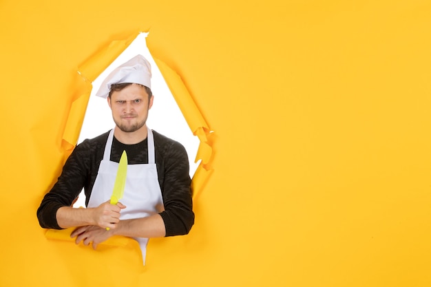 Front view young male cook in white cape on yellow background white color kitchen cuisine job man photo