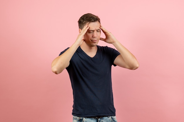 Free Photo front view young male in dark-blue shirt having slight headache on pink background male human model color emotion man