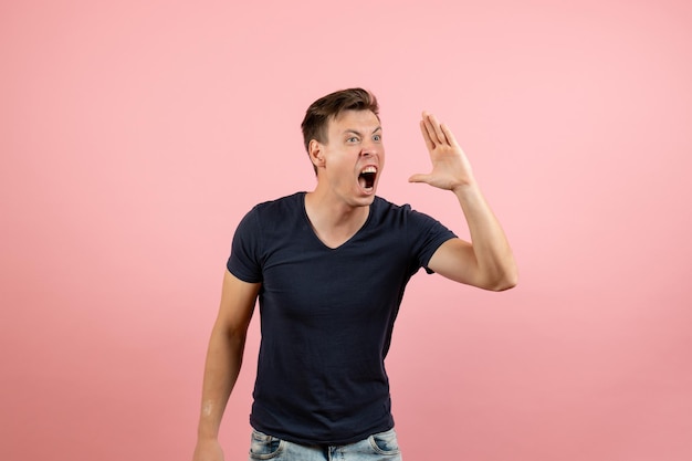 Free Photo front view young male in dark-blue shirt posing on pink background