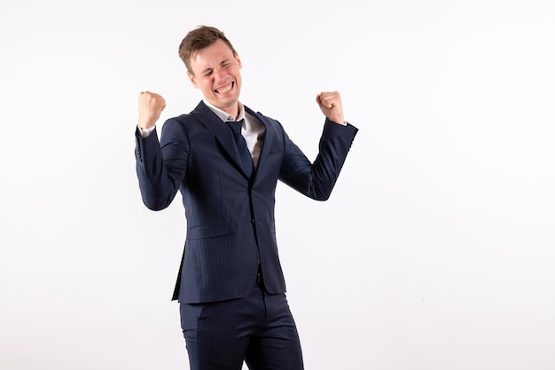 Free photo front view young male in elegant classic suit rejoicing from joy on white background