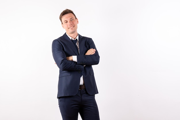 Front view young male in elegant classic suit smiling and posing on white background