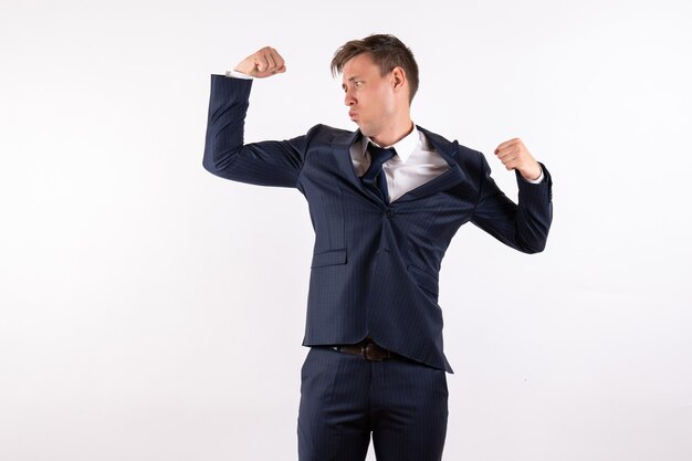 Front view young male flexing in classic strict suit on white background emotions human male suit fashion model