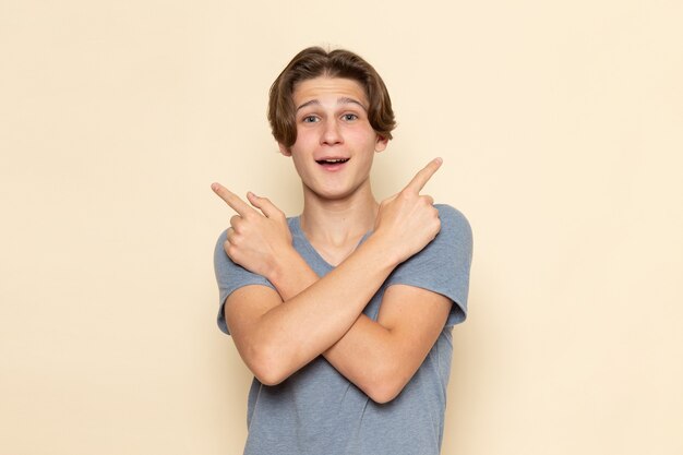 A front view young male in grey t-shirt posing with laugh