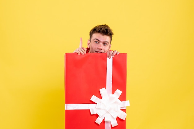 Free photo front view young male hiding inside present box