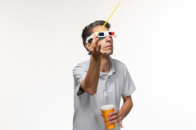 Front view young male holding soda and watching movie in d sunglasses on white desk