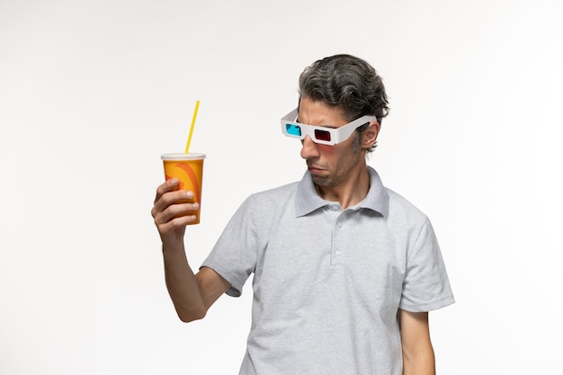 Front view young male holding soda and wearing d sunglasses on a white surface