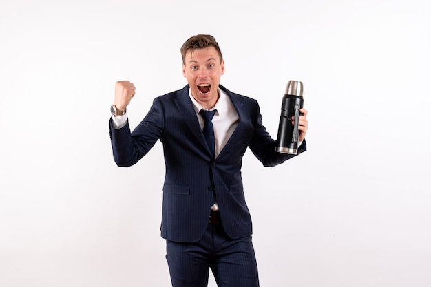 Front view young male holding thermos in classic suit on white background emotion costume fashion model human male