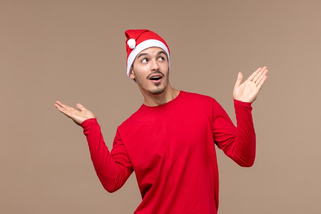 Front view young male posing on brown background emotion holiday male