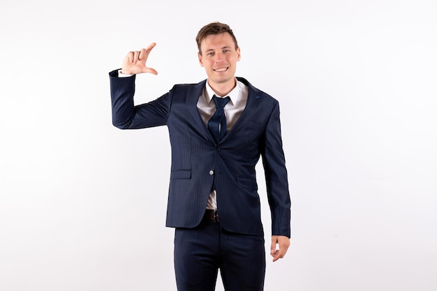 Free photo front view young male posing in classic strict suit on white background