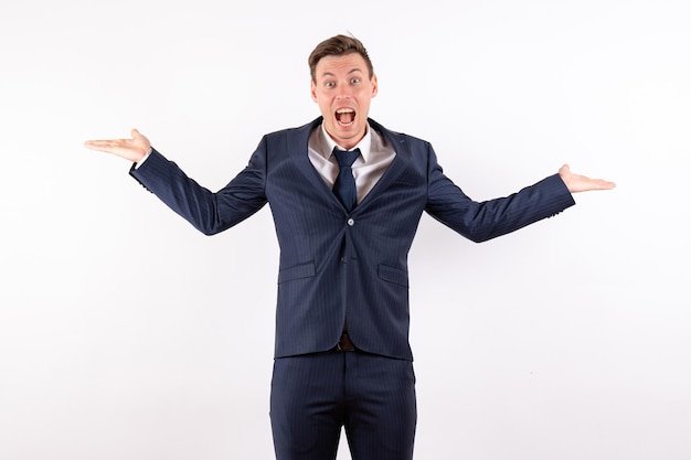 Front view young male posing in classic strict suit on white background