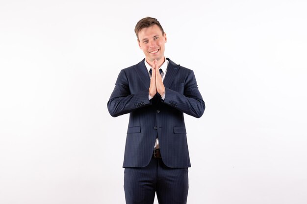 Front view young male posing with smile in classic strict suit on white background