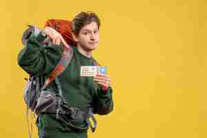 Free photo front view young male preparing for hiking holding ticket