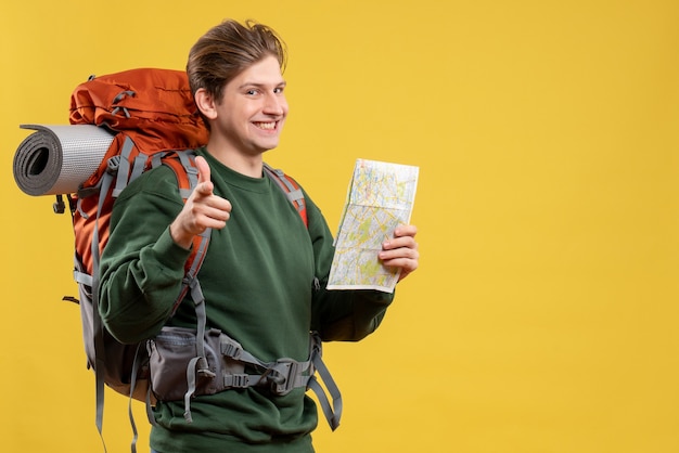 Free photo front view young male preparing for hiking observing map