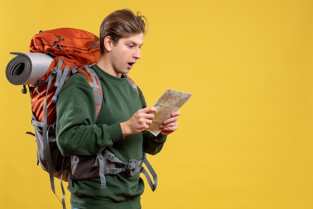 Free photo front view young male preparing for hiking observing map