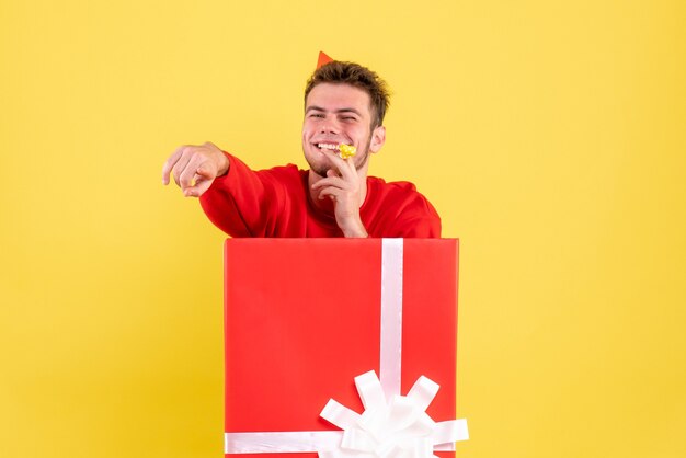 Free Photo front view young male in red shirt sitting inside present box