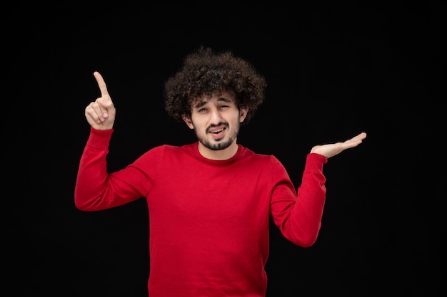 Free Photo front view of young male in red sweater on the black wall